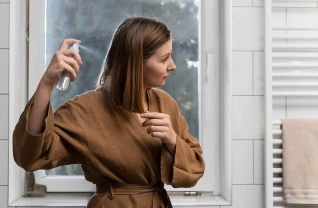 Woman spraying hair