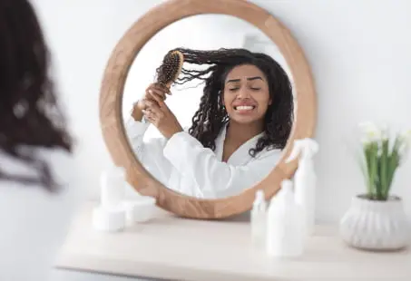 woman can't comb hair