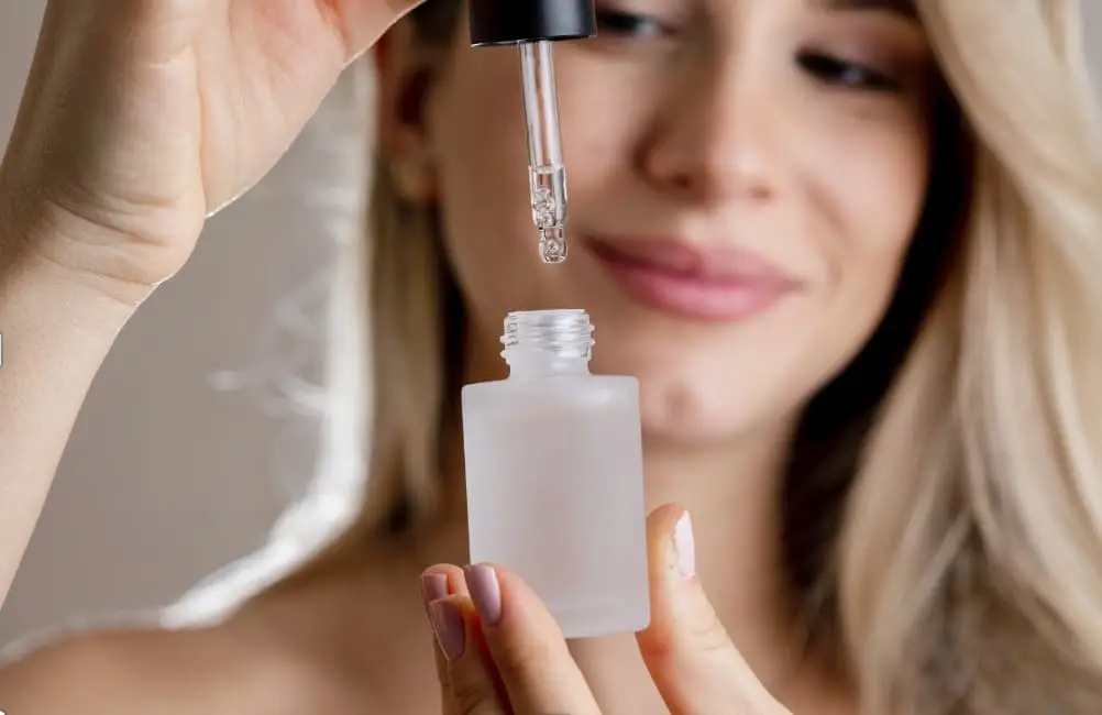 woman holding serum bottle